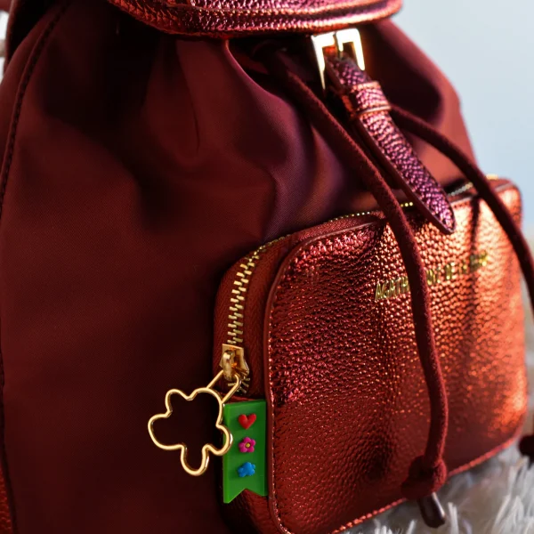 Diseño funcional y estilo contemporáneo se unen en esta mochila mediana de la colección. Con un formato práctico que incluye tapa superior y un bolsillo delantero en piel sintética metalizada, combina resistencia y sofisticación en un solo accesorio.Las correas de algodón ajustables garantizan comodidad y adaptabilidad para llevarla todo el día sin esfuerzo. Además, los detalles en dorado y el icónico tirador con la nube realzan su carácter exclusivo. Ideal para quienes buscan una mochila ligera pero con personalidad. Medidas: 21*26*11