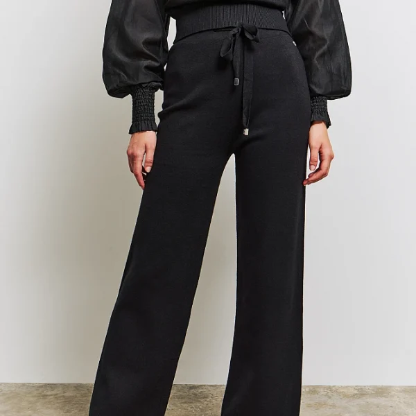 Pantalones de punto acampanados, con correa ajustable en la cintura, corte regular.